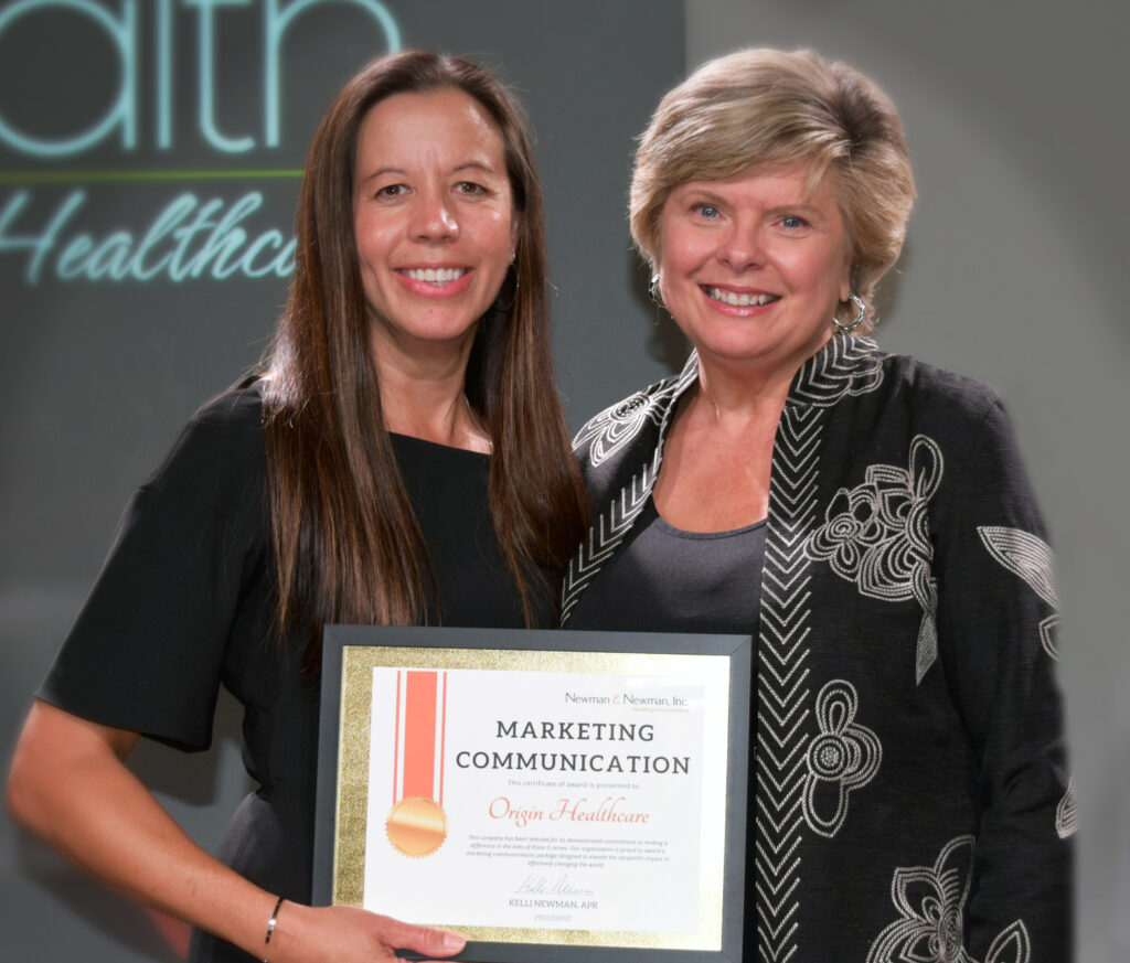 Newman and Newman, Inc President, Kelli Newman, presents Dr. Christine Lum Lung with Marketing Communication Award valued at $20,000 at the Ignite Fire Pitch Competition